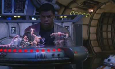 John Boyega in Star Wars looking at a holographic chess game