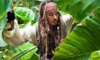 Johnny Depp as Captain Jack Sparrow hiding amongst plants