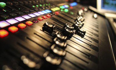 A sound board in a recording studio with sliders at various points